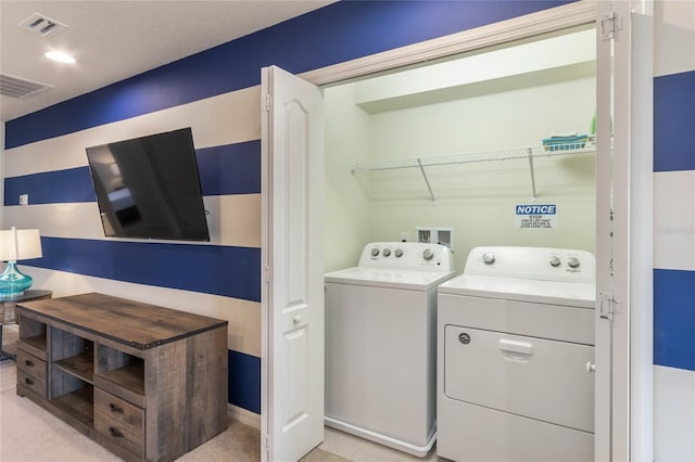 laundry area featuring light colored carpet and washing machine and clothes dryer