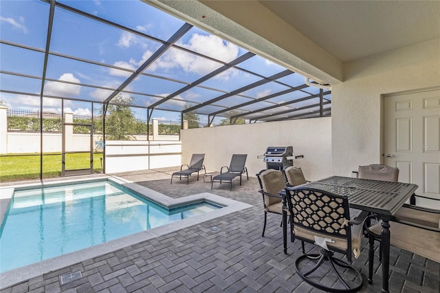 view of swimming pool featuring glass enclosure and a patio