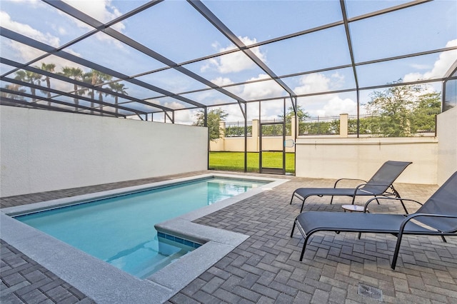 view of swimming pool featuring a lanai and a patio