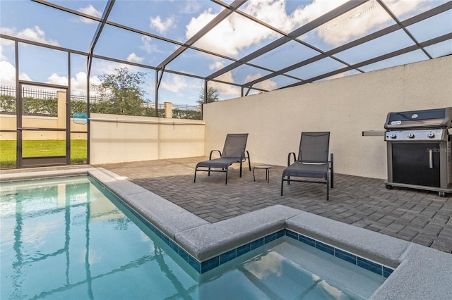 outdoor pool featuring a patio area, glass enclosure, area for grilling, and a jacuzzi