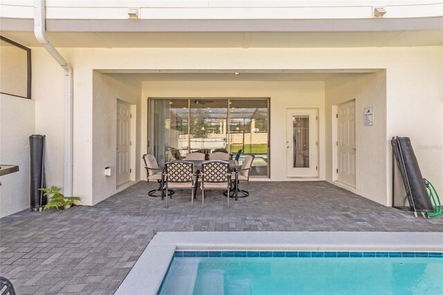 pool featuring a patio and outdoor dining space