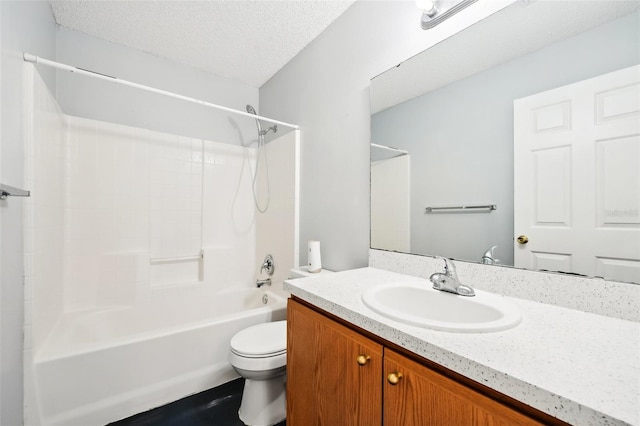 full bathroom featuring washtub / shower combination, vanity, toilet, and a textured ceiling