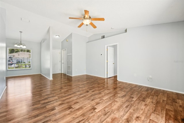 unfurnished living room with vaulted ceiling, ceiling fan with notable chandelier, and hardwood / wood-style flooring