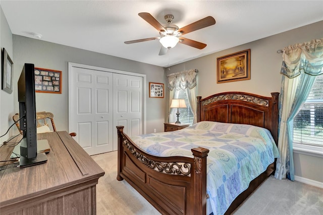 10604 SE 146th Ln, Summerfield, FL 34491 - bedroom featuring light carpet, baseboards, a ceiling fan, and a closet