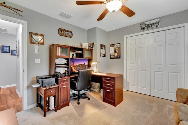 office with ceiling fan and light carpet