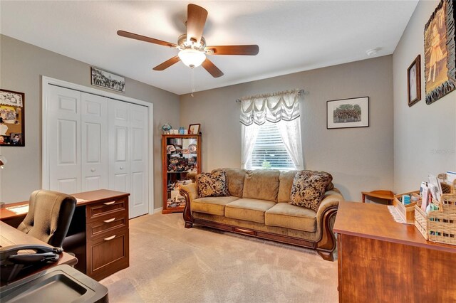 carpeted office featuring ceiling fan