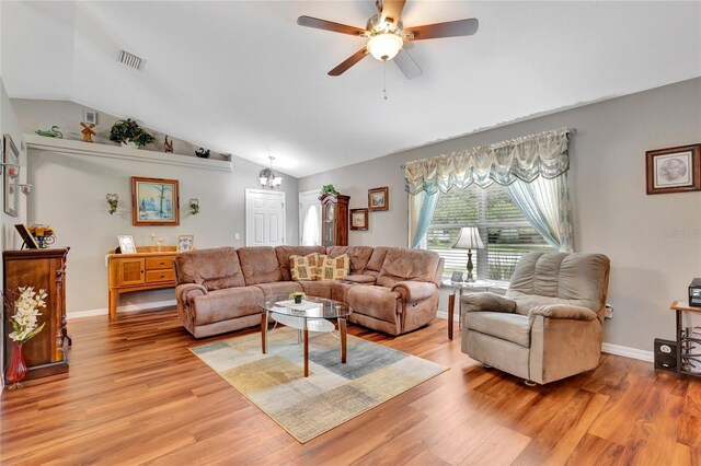 living room with light hardwood / wood-style flooring, ceiling fan, and vaulted ceiling