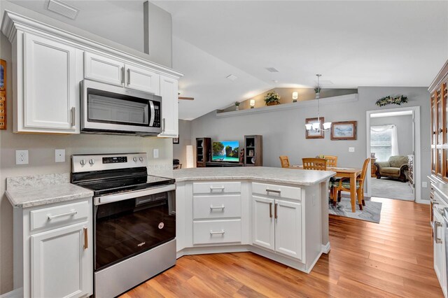 kitchen with light wood-type flooring, kitchen peninsula, appliances with stainless steel finishes, lofted ceiling, and white cabinets