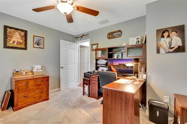 office space featuring ceiling fan and light carpet