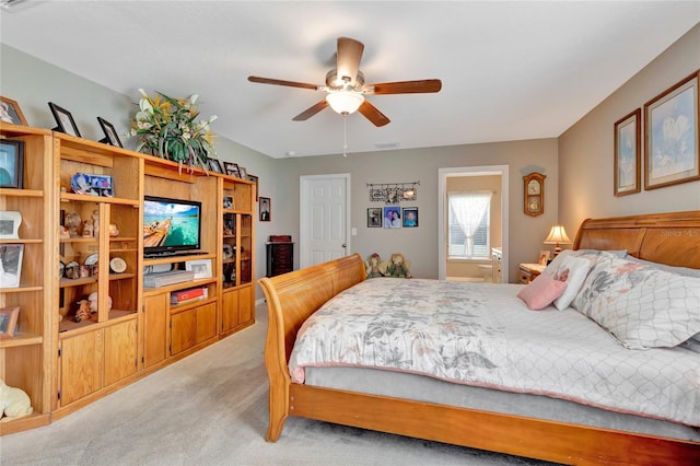 10604 SE 146th Ln, Summerfield, FL 34491 - bedroom with visible vents, light colored carpet, ensuite bathroom, and ceiling fan