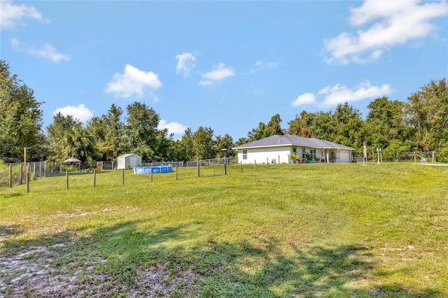10604 SE 146th Ln, Summerfield, FL 34491 - view of yard featuring an outbuilding, a storage unit, and fence