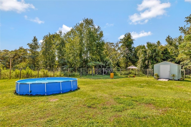 10604 SE 146th Ln, Summerfield, FL 34491 - view of yard with an outdoor pool, an outbuilding, a storage shed, and fence