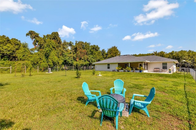 view of yard featuring a fire pit and a patio