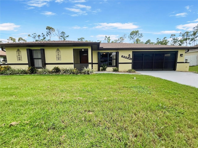 view of front of house featuring a garage, concrete driveway, a front yard, and stucco siding