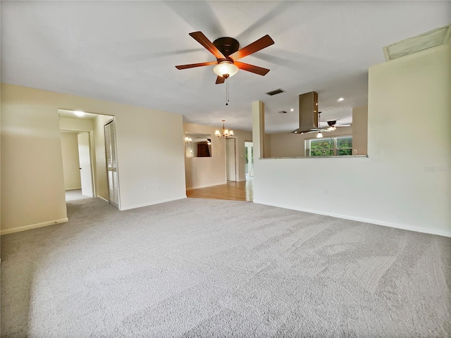 spare room with light carpet, baseboards, visible vents, and ceiling fan with notable chandelier