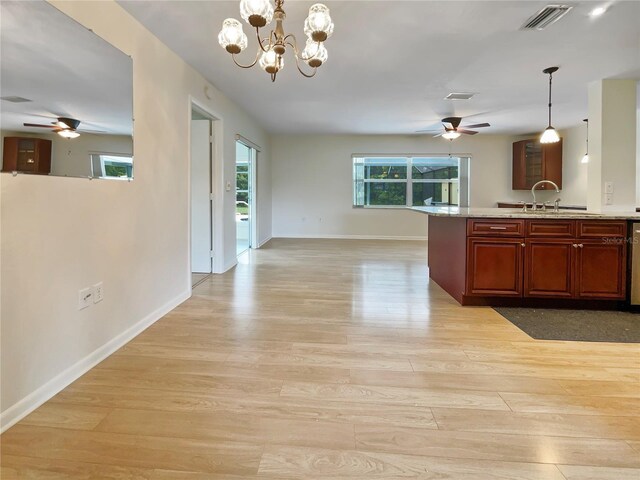 kitchen with open floor plan, visible vents, a sink, and decorative light fixtures