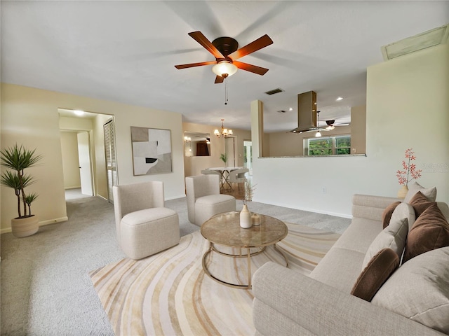 living room with ceiling fan with notable chandelier and light colored carpet