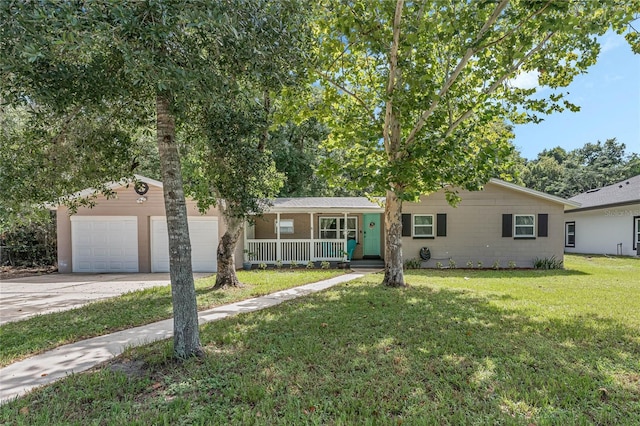 ranch-style house featuring an attached garage, a front lawn, a porch, and concrete driveway