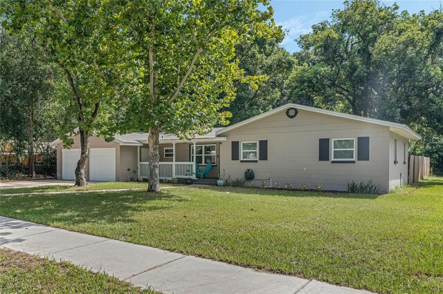 ranch-style home featuring a garage and a front lawn