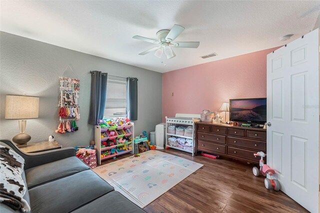 recreation room featuring ceiling fan and dark wood-type flooring