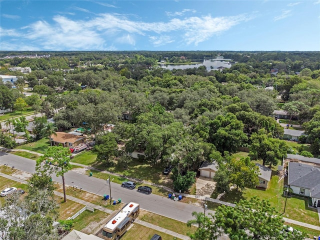 aerial view featuring a water view and a view of trees