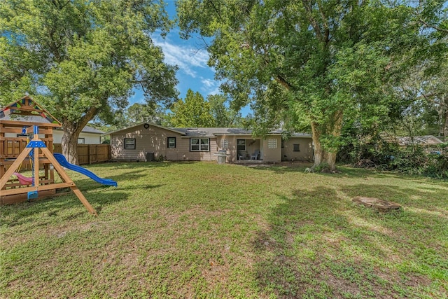 view of yard with a playground and fence