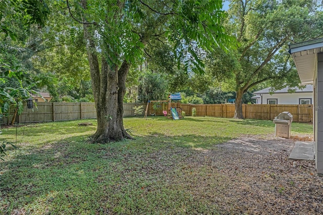 view of yard featuring a fenced backyard and a playground