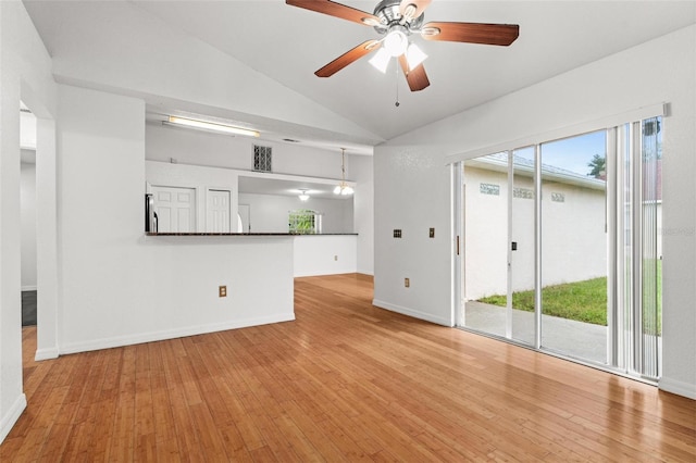 interior space featuring ceiling fan, vaulted ceiling, and light hardwood / wood-style flooring