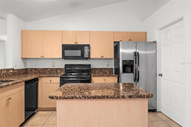 kitchen with dark stone counters, black appliances, a center island, and lofted ceiling