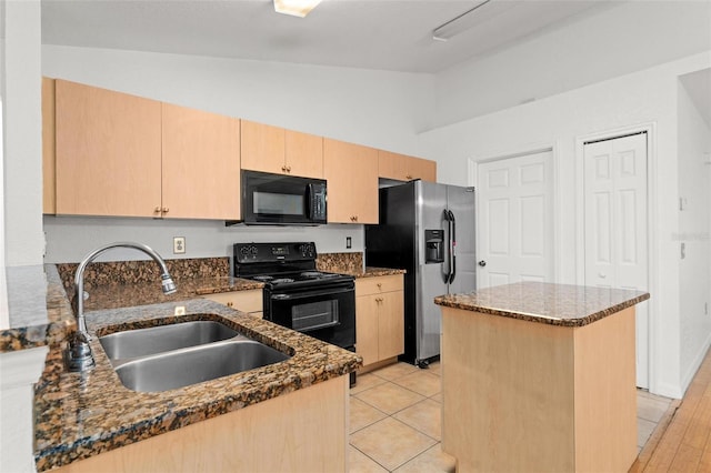 kitchen featuring a kitchen island, sink, dark stone countertops, black appliances, and lofted ceiling