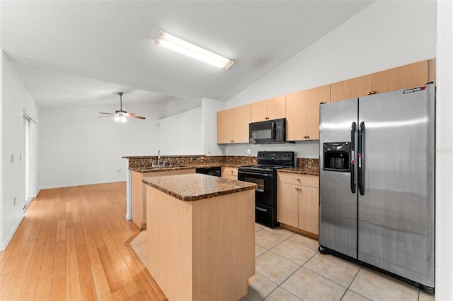 kitchen with light hardwood / wood-style flooring, vaulted ceiling, ceiling fan, kitchen peninsula, and black appliances