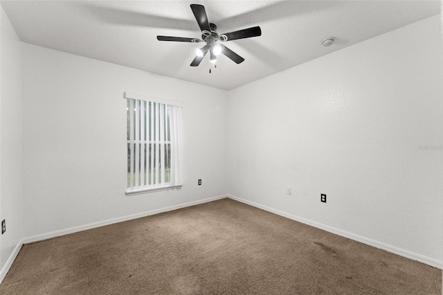 spare room with carpet floors and ceiling fan