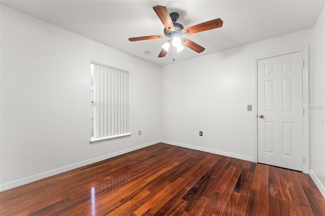 empty room featuring ceiling fan and dark wood-type flooring