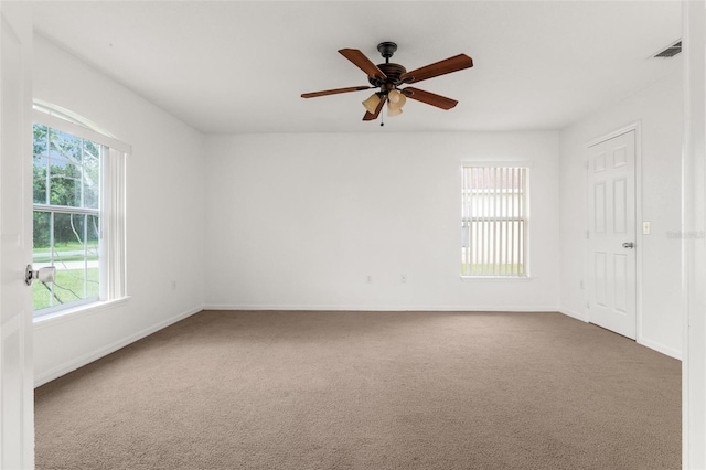 carpeted spare room with ceiling fan