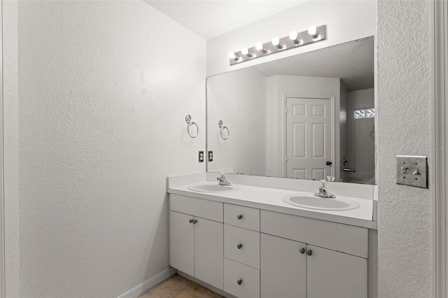 bathroom with tile patterned floors and vanity