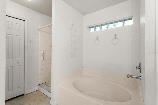 bathroom with tile patterned flooring and separate shower and tub