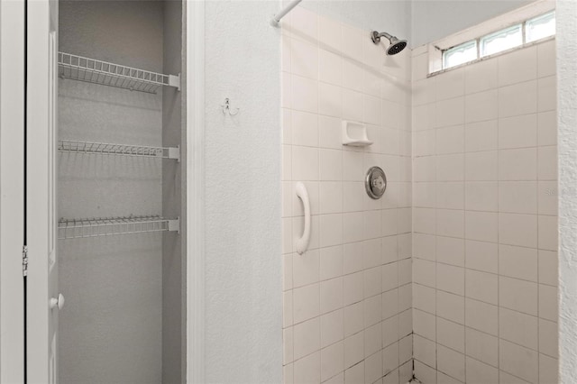 bathroom with tiled shower