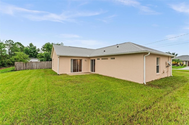 rear view of house with a yard