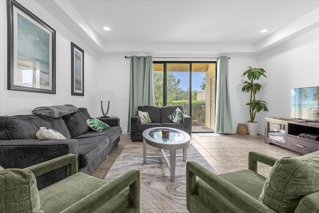 living room featuring light tile patterned floors and a tray ceiling