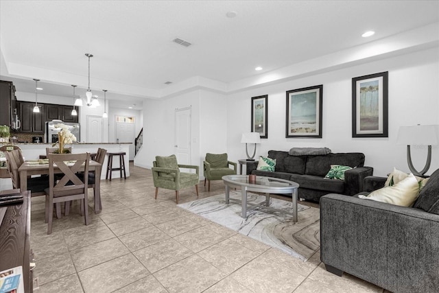 8110 Roseville Rd, Davenport, FL 33896 - living room with recessed lighting, visible vents, light tile patterned flooring, and stairs