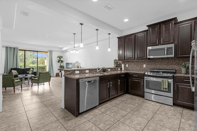 8110 Roseville Rd, Davenport, FL 33896 - kitchen with visible vents, a sink, open floor plan, appliances with stainless steel finishes, and decorative backsplash