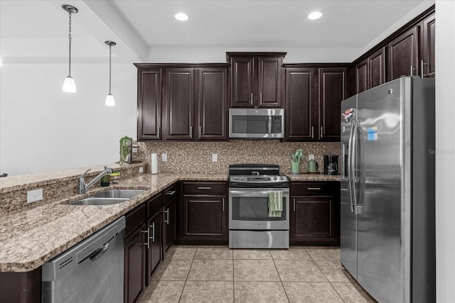 kitchen featuring decorative backsplash, light tile patterned floors, sink, kitchen peninsula, and stainless steel appliances