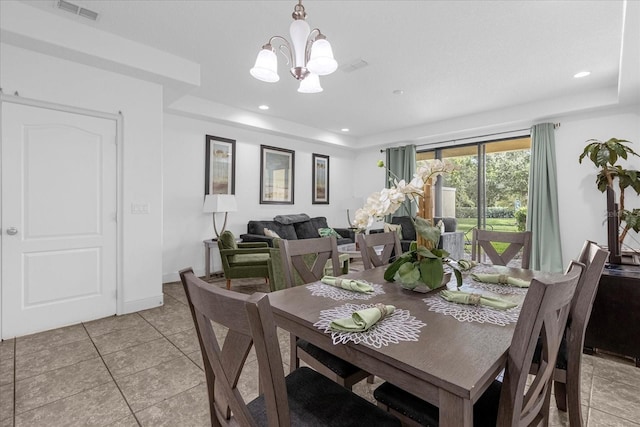 8110 Roseville Rd, Davenport, FL 33896 - dining area with a tray ceiling, light tile patterned flooring, visible vents, and a chandelier