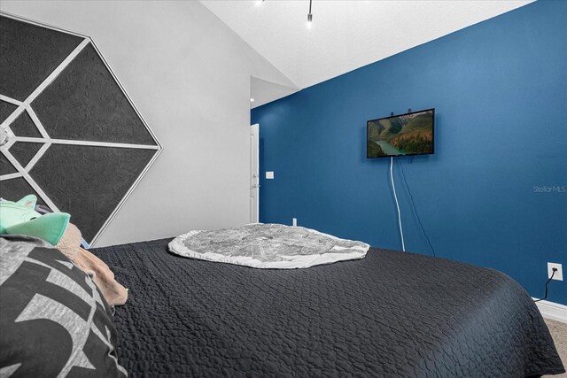 8110 Roseville Rd, Davenport, FL 33896 - bedroom featuring vaulted ceiling and carpet