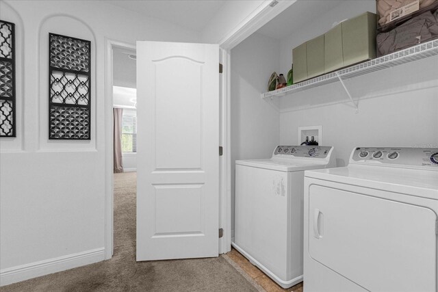 8110 Roseville Rd, Davenport, FL 33896 - laundry area featuring light carpet, laundry area, baseboards, and separate washer and dryer
