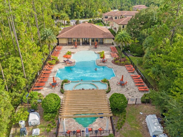 view of swimming pool with a hot tub and a patio