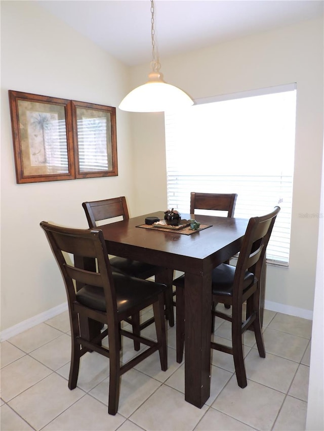 dining area featuring baseboards and light tile patterned floors