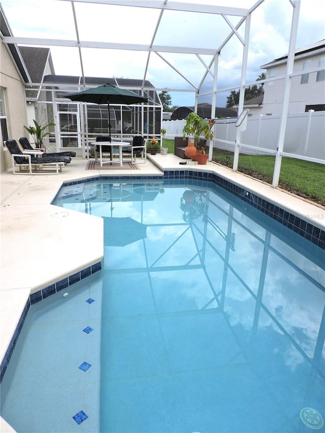 view of swimming pool with a fenced in pool, a lanai, a patio area, and fence