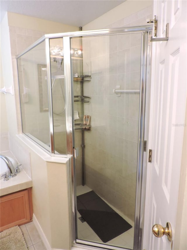 bathroom with a garden tub, tile patterned flooring, and a shower stall