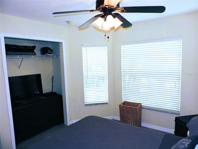 bedroom featuring ceiling fan, a closet, and baseboards